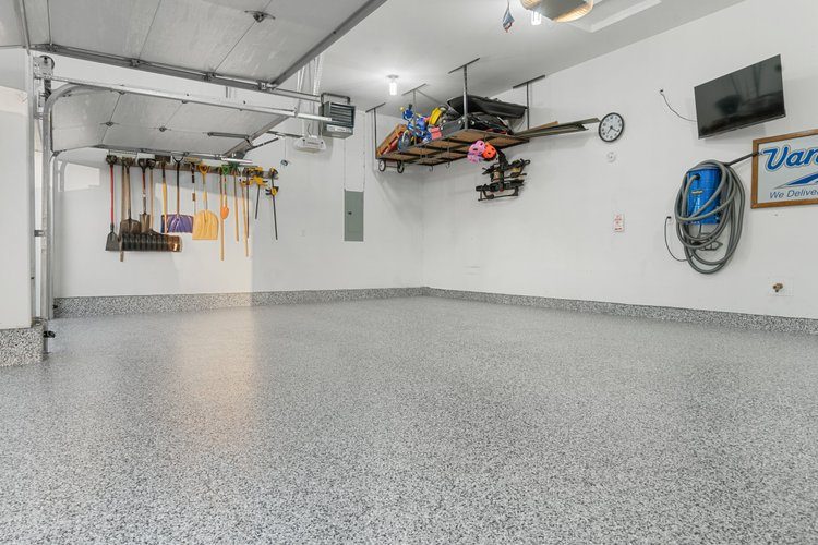 Finished garage floor coating with organized workspace